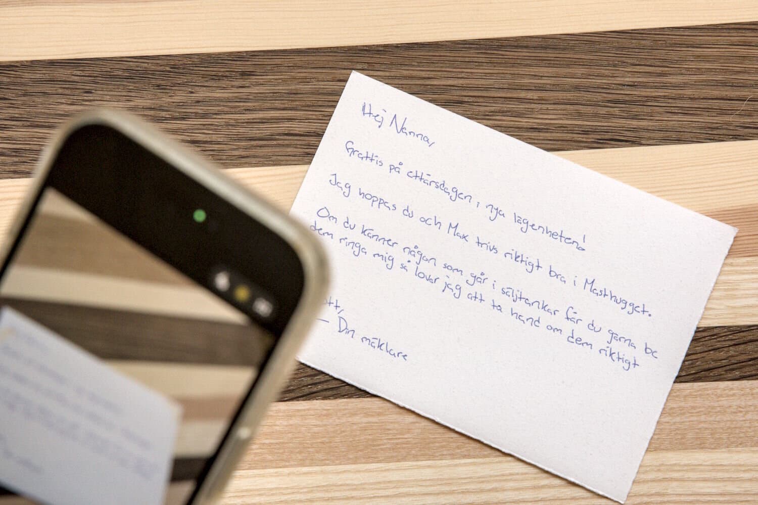 Someone taking a photo of a handwritten letter with their phone